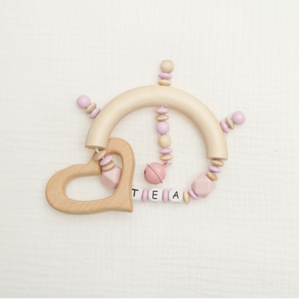 Gripper made of silicone and wood with little bell and heart, pink